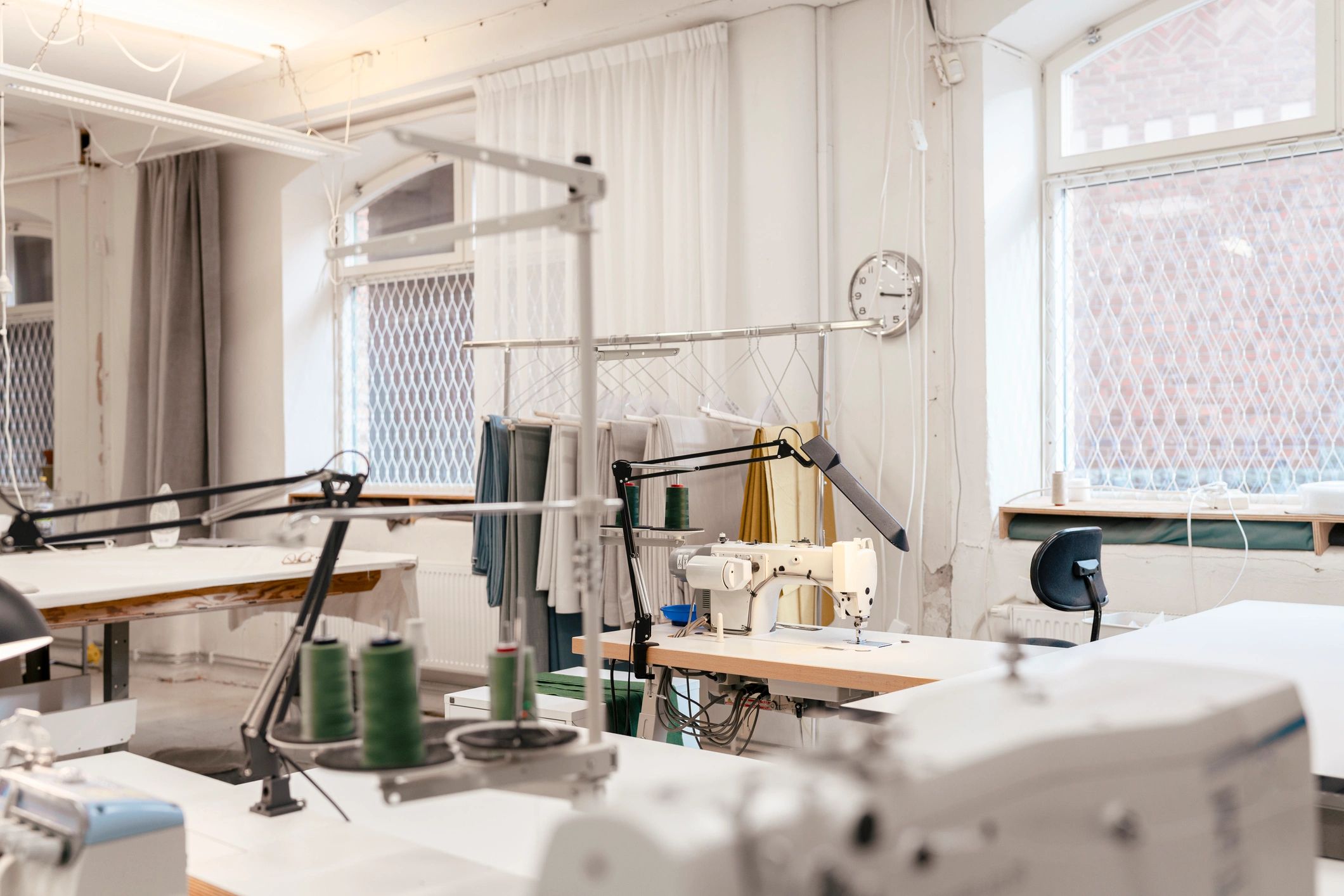 Bright sewing workshop with fabrics and worktables